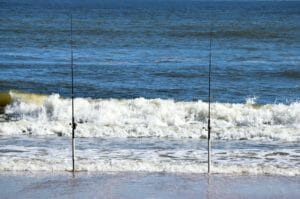 fishing poles in the surf