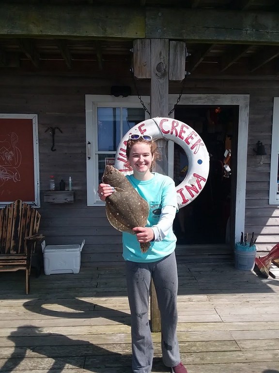Happy customer with her catch on the dock at Whale Creek Marina May 2019